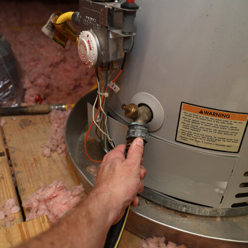 plumber working on a tank water heater