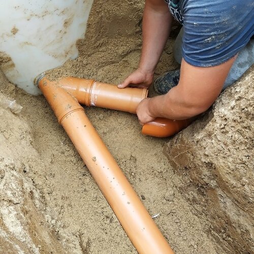close-up of a worker providing sewer line repair